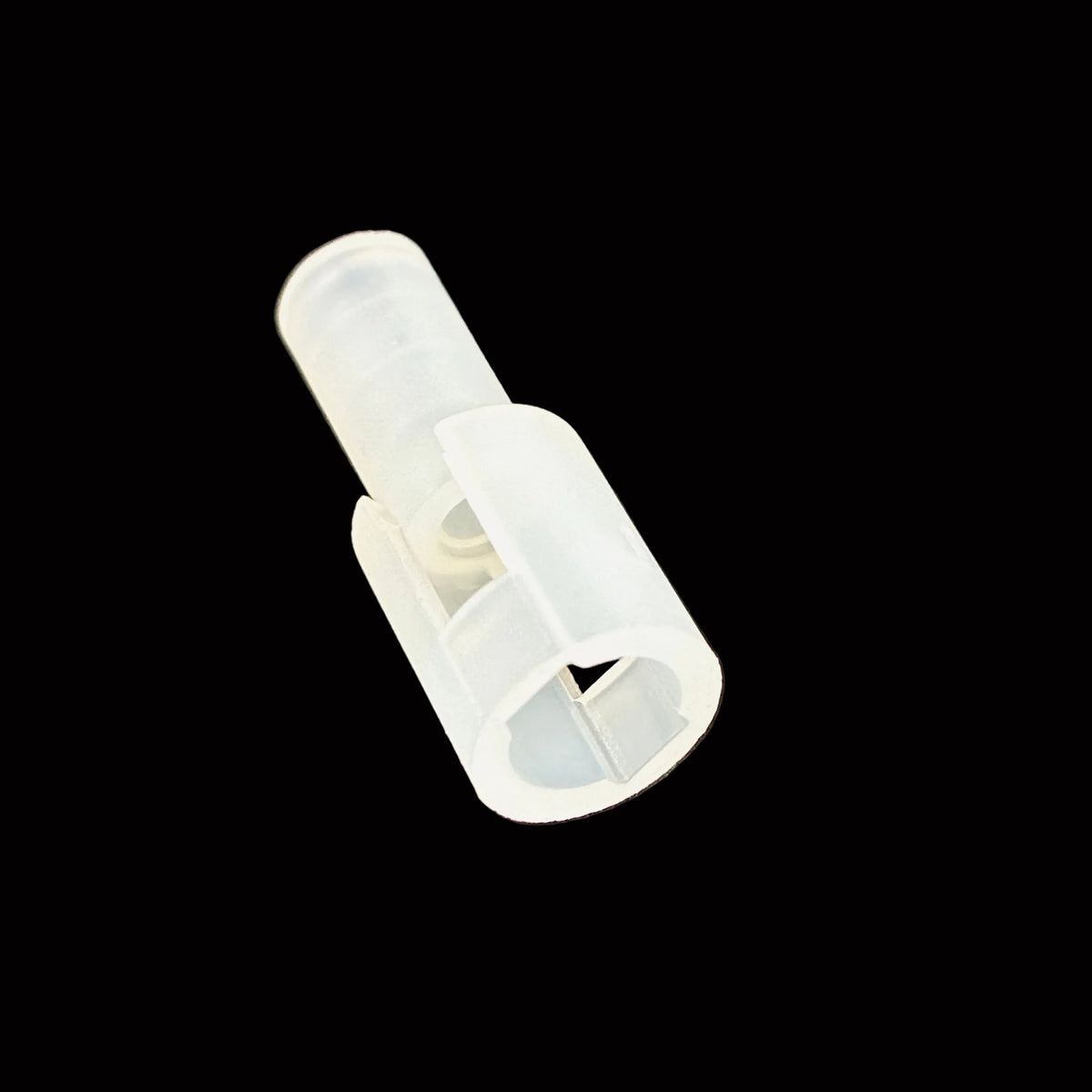 A small translucent white plastic clip or connector piece photographed on a black surface.