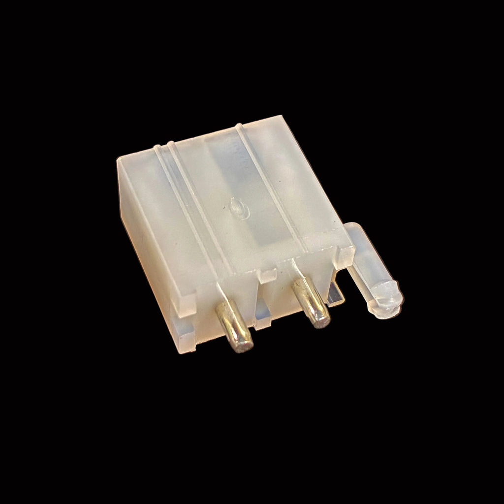 A small translucent plastic electronic component with three metal pins, photographed on a black surface.